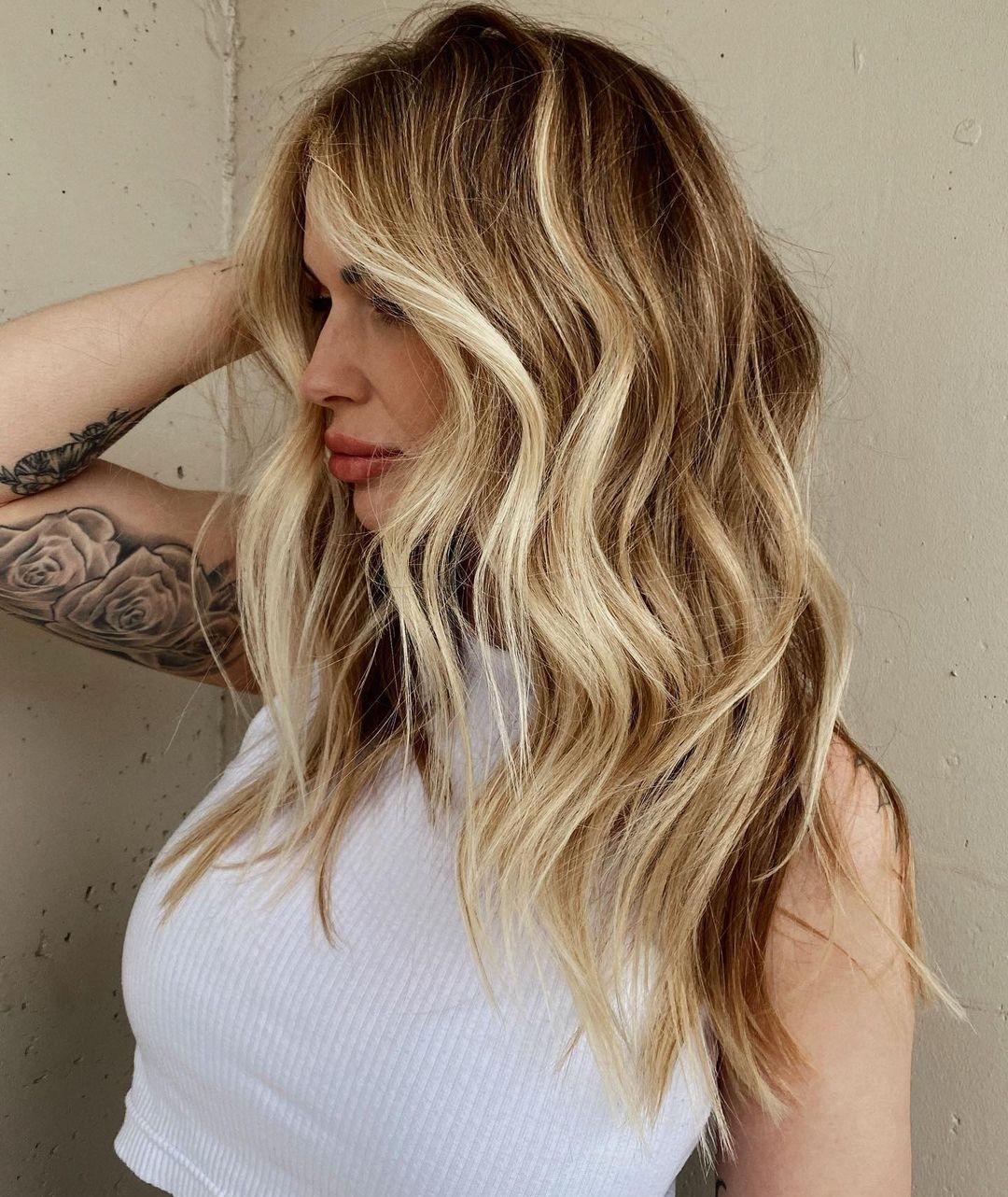 Effortlessly chic and sun-kissed, this blonde balayage hairstyle radiates warmth and sophistication. Perfect for adding depth and dimension to your look!" ✨💁‍♀️ #BlondeBalayage #HairGoals