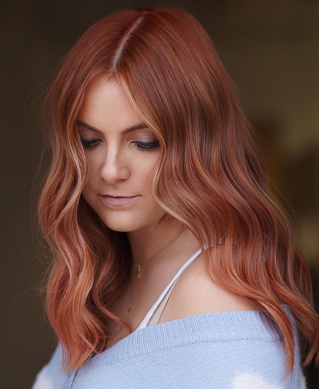 Radiating warmth and vibrancy, this dark strawberry hair with soft blonde highlights creates a stunning contrast that beautifully frames the face. A perfect blend of rich tones for a fresh and modern look!