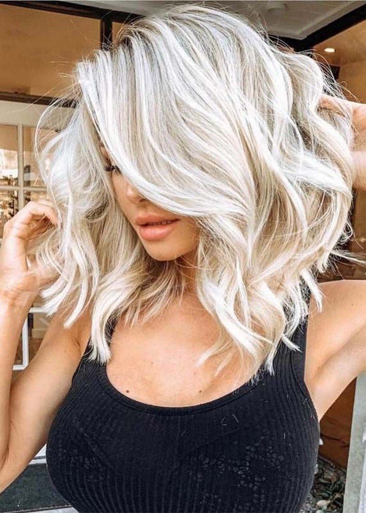 Effortlessly chic! This blonde hairstyle exudes elegance with its soft waves and radiant shine, perfect for any occasion.