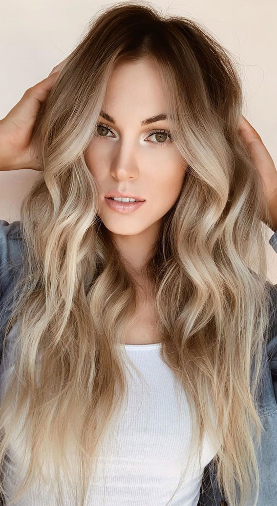 Embrace the glow with this stunning blonde hairstyle, blending warm tones and effortless waves for a radiant look that turns heads!