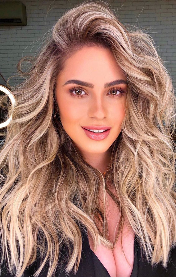 Embrace the sun-kissed vibes with this stunning blonde hairstyle, radiating warmth and elegance. Perfectly tousled for a carefree yet chic look!" 🌟✨