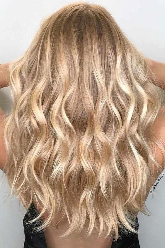 Radiating warmth and style, this stunning blonde hairstyle with subtle highlights adds depth and dimension, perfect for turning heads this season!